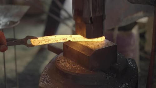 The Process Of Iron Forging Using A Press In A Blacksmith Ironwork Workshop