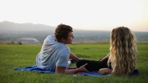 Couple Relaxing on Blanket at Sunset