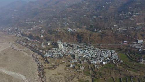 Aerial View of a Village Nestled in Mountains