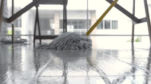 Mop Cleaning Shiny Floor in Modern House