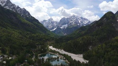 Cinematic Aerial, Alpine Lake and Snow Covered Mountain Valley Vista
