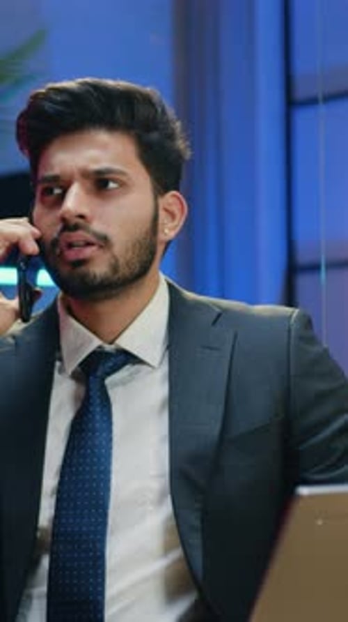 Young Professional Man Talking on Phone in Office
