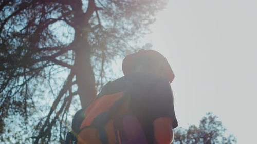 Man Walking in Park Hiker Adventurer Enjoys Hiking a Scenic Trail Near Majestic Mountains Tourist