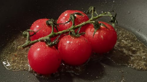 Fresh Cherry Tomatoes in a Frying Pan with Olive Oil and Spices Cooking Tomato Sauce Traditional