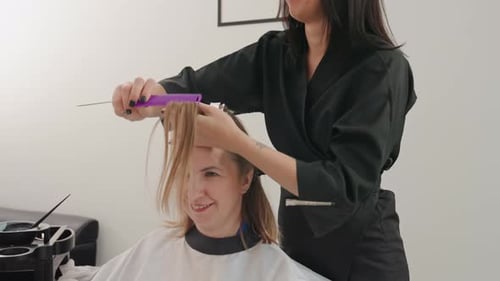 Woman Getting Hair Styled by Hairdresser in Salon