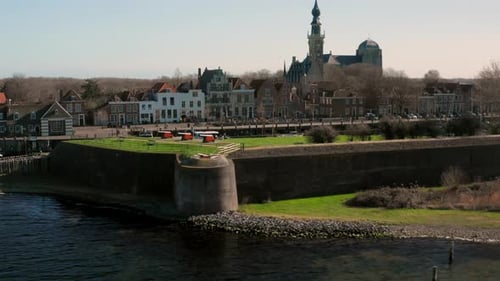 Aerial: The historical town of Veere with an old harbour and churches, on a spring day.