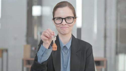Portrait of Female Real Estate Agent Showing Home Keys