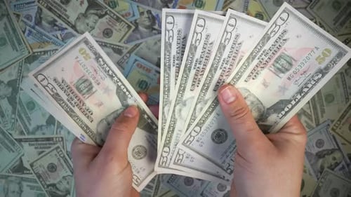 Hands Counting US Fifty and One Hundred Dollar Bills