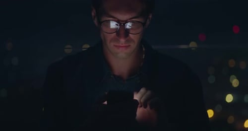 Young Adult Using Smartphone at Night