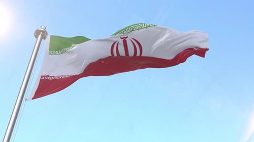 Waving Iran Flag Against Blue Sky Background