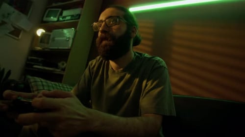 Man Playing Video Game on Couch at Night