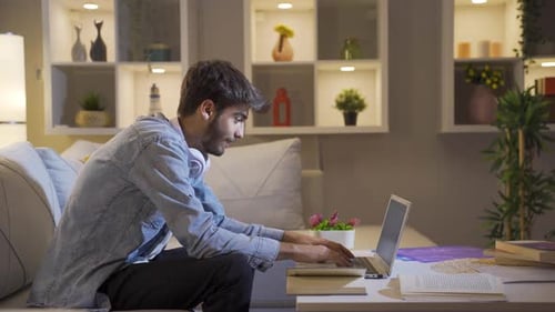 Young Adult Using Laptop at Home