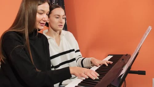 Teacher and Student Learn Notes of New Song By Playing Piano