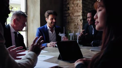 Professional Business Meeting with Wind Turbine Models