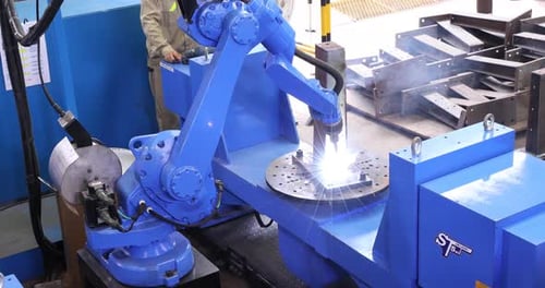 Robotic Welder Welding Metal Structure With Sparks And Smoke. static