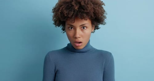 Surprised Woman Reacting to Something Unexpected in Studio