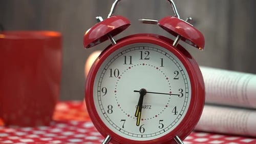 Morning coffee newspaper and a ringing alarm clock