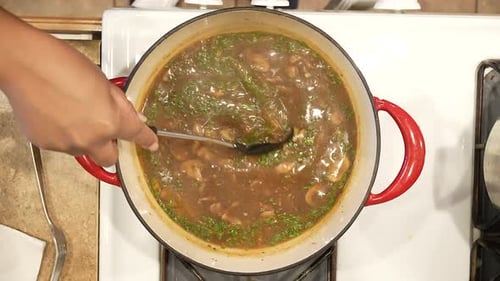 Mushroom Soup Being Stirred in Pot Overhead