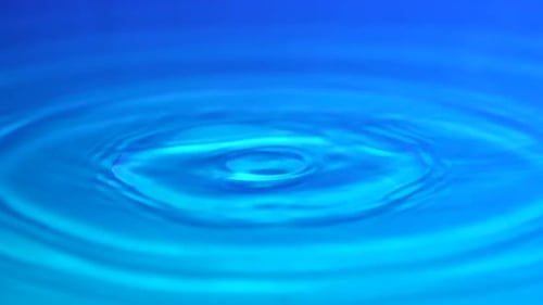 Water Droplet Impact in Blue Liquid Environment