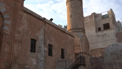 The camera tilts the minaret of the Latifiye Mosque in Mardin from bottom to top. Behind the minaret
