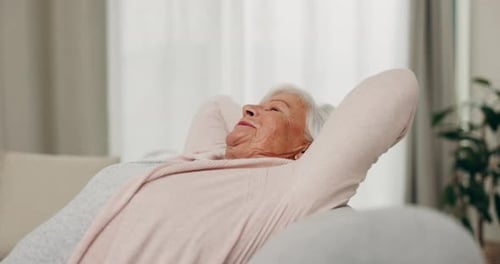 Smile, relax and senior woman stretching on sofa in home living room for peace