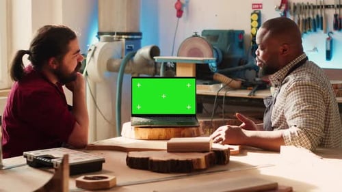 Joyous Cabinetmaker Look Over Blueprints Schematics on Isolated Screen Laptop