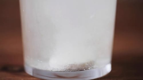 Effervescent Tablet Dissolving in Glass of Water