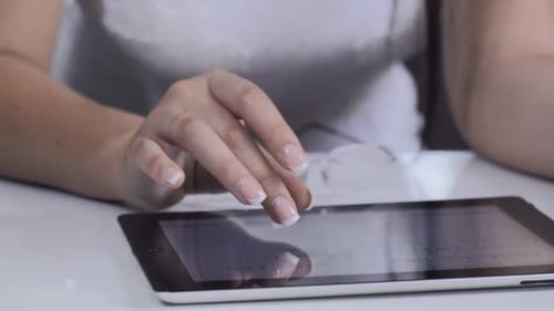 Woman Using Tablet Device with Finger Gestures
