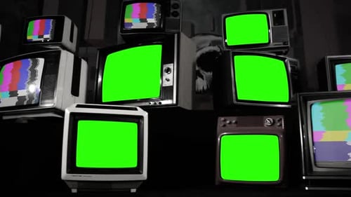 Five Stacked Vintage Televisions Turning On Green Screens.