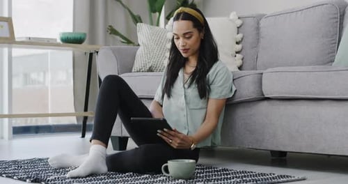 Woman Using Tablet While Relaxing at Home