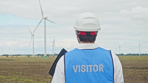Engineer is Watching Correct Operation of Wind Turbines with Interest Which Generate Environmentally