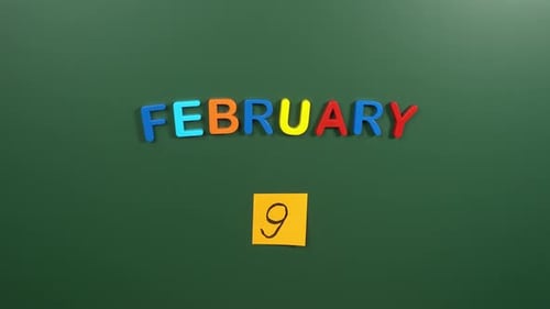Hand sticking a sticker 9 February calendar day on school board. 9 date of February. Ninth day