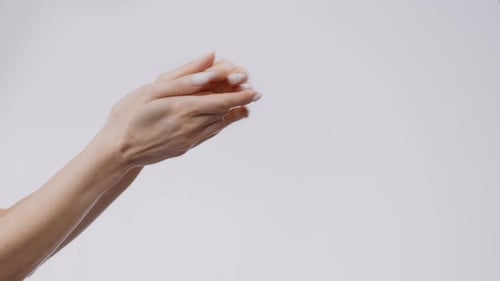 Woman's Hands Performing Massage Against White Background