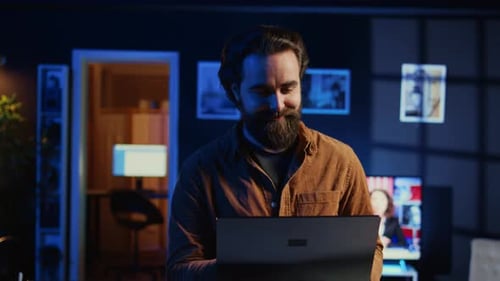 Portrait of Smiling Man Doing IT Support Job From Home Standing in Office