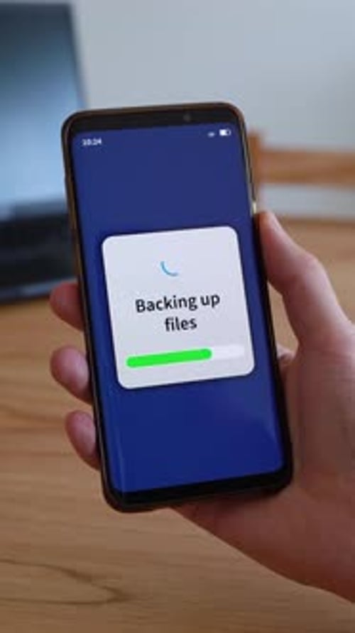 Backing up smartphone files on cloud storage. Concept of backup. Vertical shot.