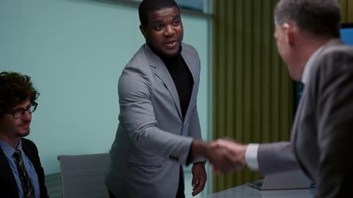 Businessmen Shaking Hands in a Corporate Office
