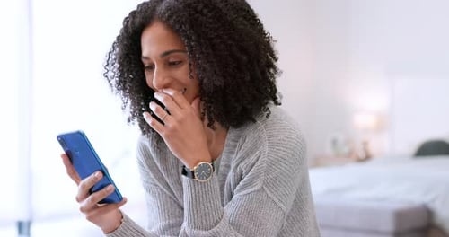 Woman Smiling While Using Smartphone Indoors