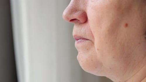 Woman Taking Pill with Water Close Up