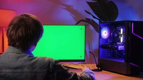 Computer with Chroma Key Green Screen on Monitor Gamer Man Playing in Popular Video Games Programmer