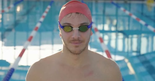 Smiling Swimmer in Cap and Goggles by Pool