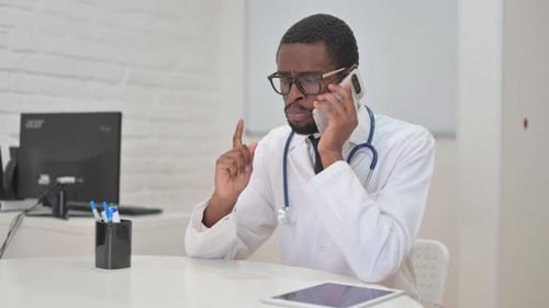 Doctor Talking on Cell Phone in Office