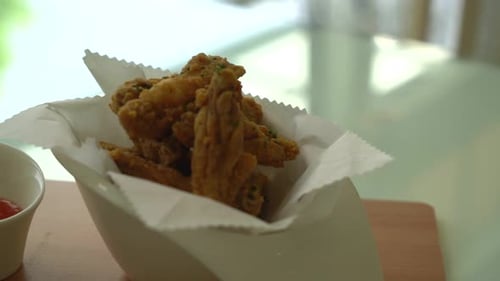 fried chicken wings on wood board