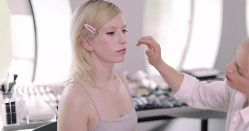 Makeup artist working on a model on a photoshoot