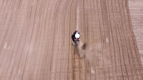 Tractor plowing the field - Red tractor plowing the field, 4k aerial shot with drone