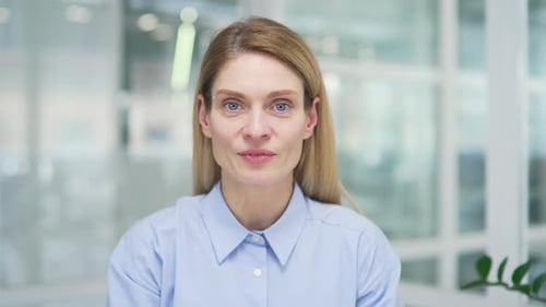 Webcam view. Close up. Businesswoman talking on a video call looking at the camera while sitting