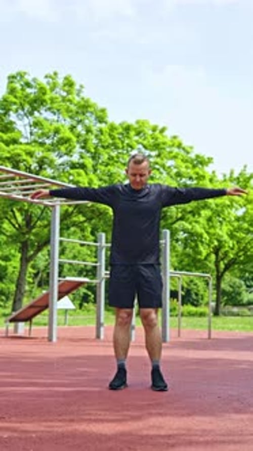 Man Stretching and Warming Up in Urban Park