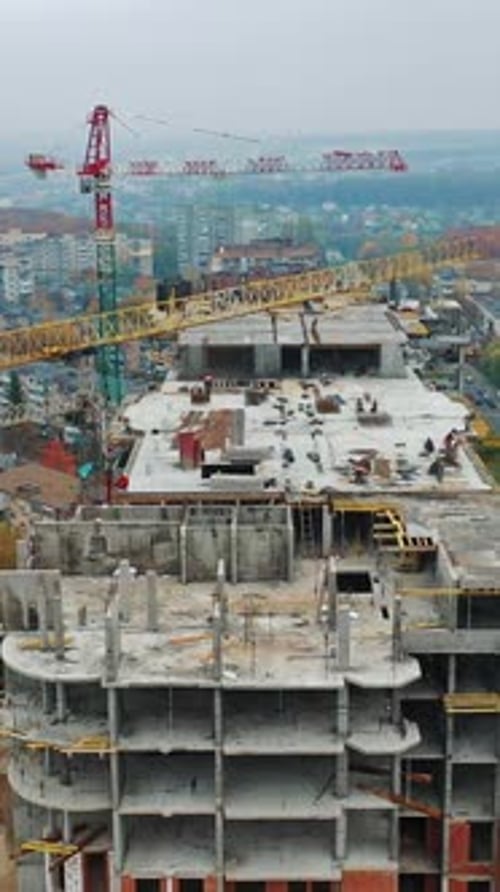 Baustelle mit Kränen. Luftaufnahme des Wolkenkratzergebäudes im Bauprozess