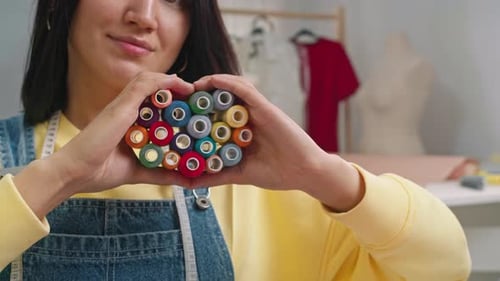 Woman Forms Thread into Heart Shape