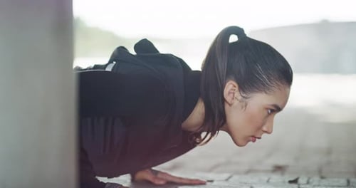 Woman Doing Pushups in an Urban Setting