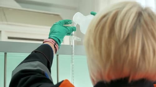 Chemists Mixing Up Solutions at the Lab Clip View Over the Shoulder of a Woman in Gloves Pouring